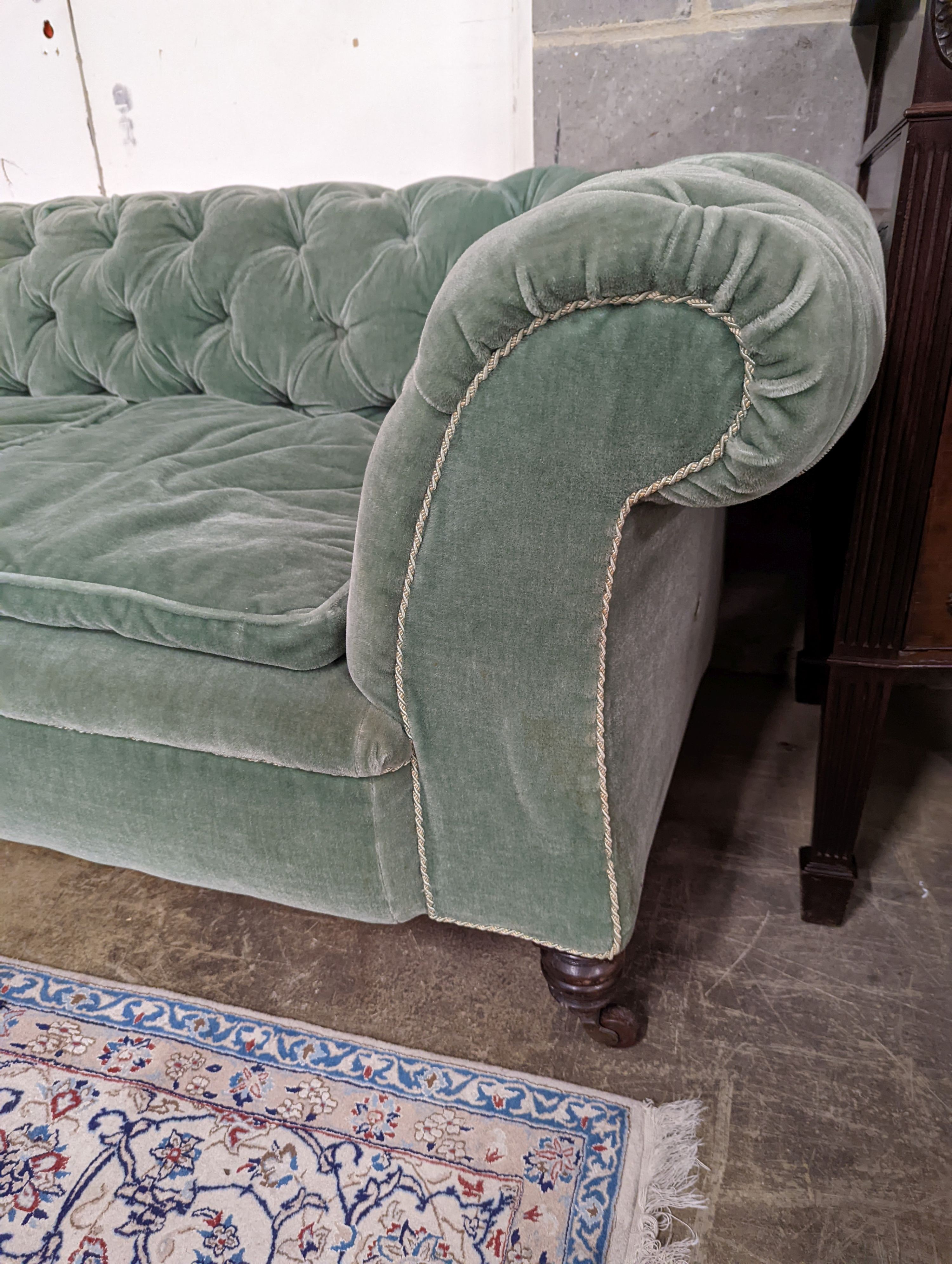 A late Victorian double drop arm Chesterfield settee upholstered in green fabric, length 186cm, depth 84cm, height 70cm